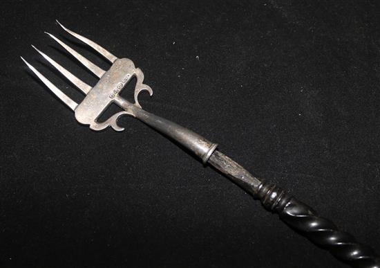 A Victorian silver four pronged toasting fork, with turned and ebony handle, Chester 1897, by Nathan and Hayes, 44.5cm.